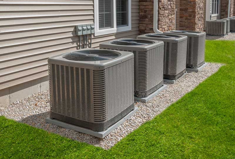 Row of outdoor AC units beside a building